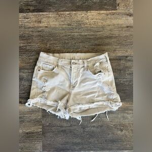 Beige distressed shorts